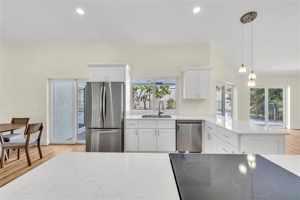 8410 Sawpine Road Delray Beach, FL 33446 - Photo 14 of 37 a kitchen with a refrigerator and microwave