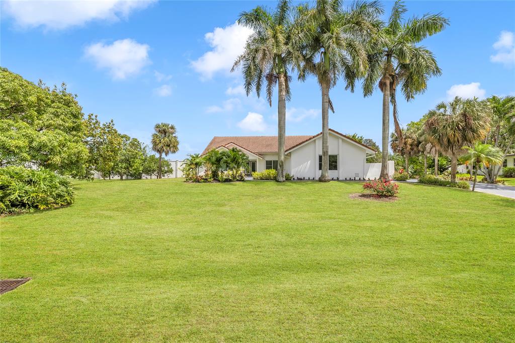 8410 Sawpine Road Delray Beach, FL 33446 - Photo 6 of 37 a view of a garden with palm trees