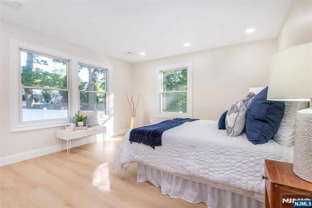 145 Grove Street Mahwah, NJ 07430 - Photo 15 of 30 a bedroom with a large bed and wooden floor