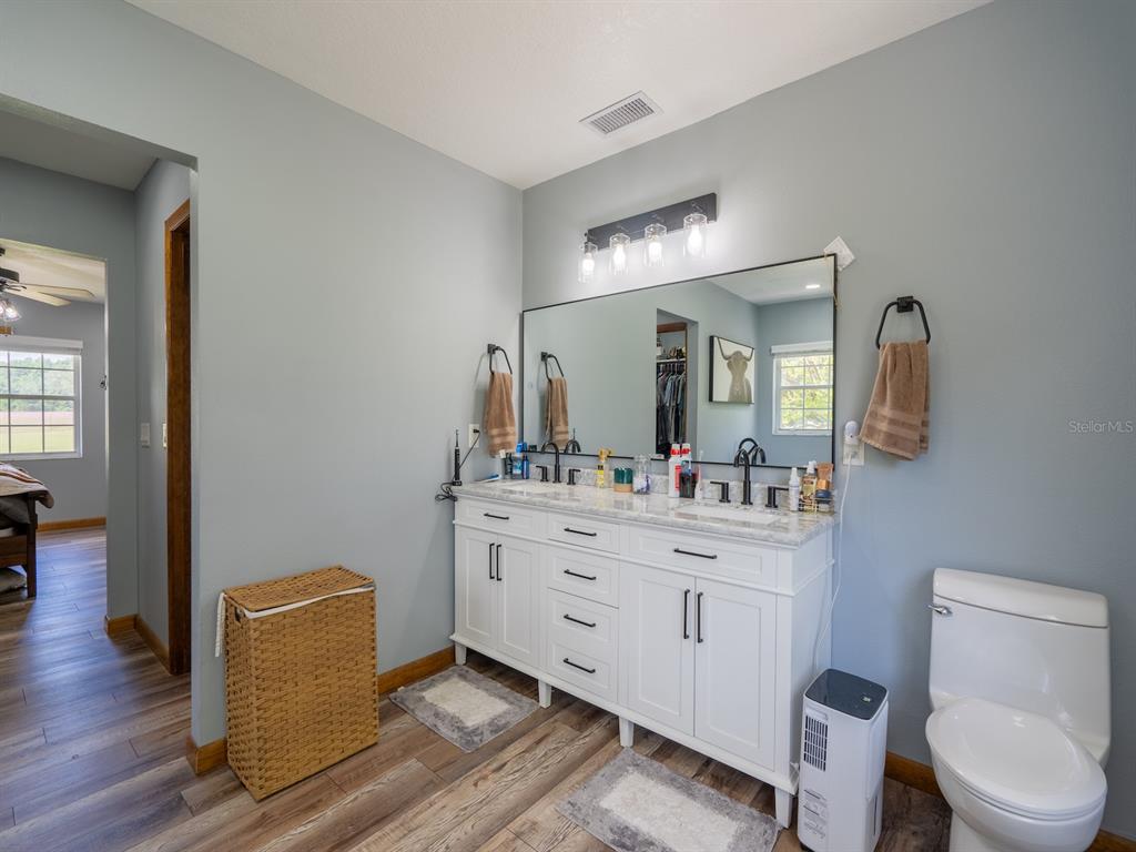 4381 Northeast 105th Place Anthony, FL 32617 - Photo 24 of 49 a spacious bathroom with a toilet sink and mirror