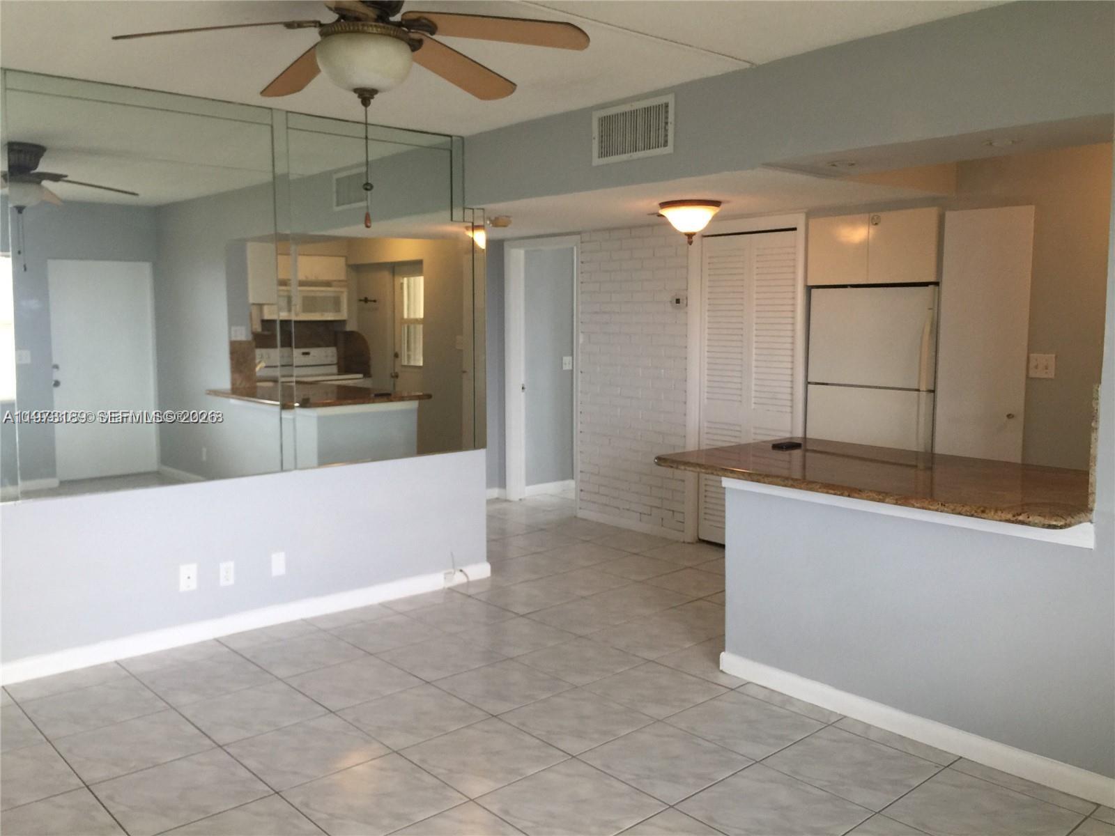 901 South Surf Road, Unit 402 Hollywood, FL 33019 - Photo 4 of 25 a view of cabinets and a glass door