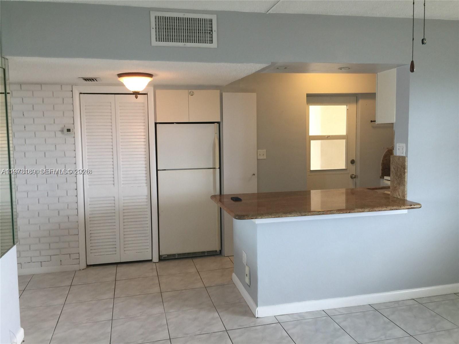 901 South Surf Road, Unit 402 Hollywood, FL 33019 - Photo 5 of 25 a view of a kitchen with a sink and a window