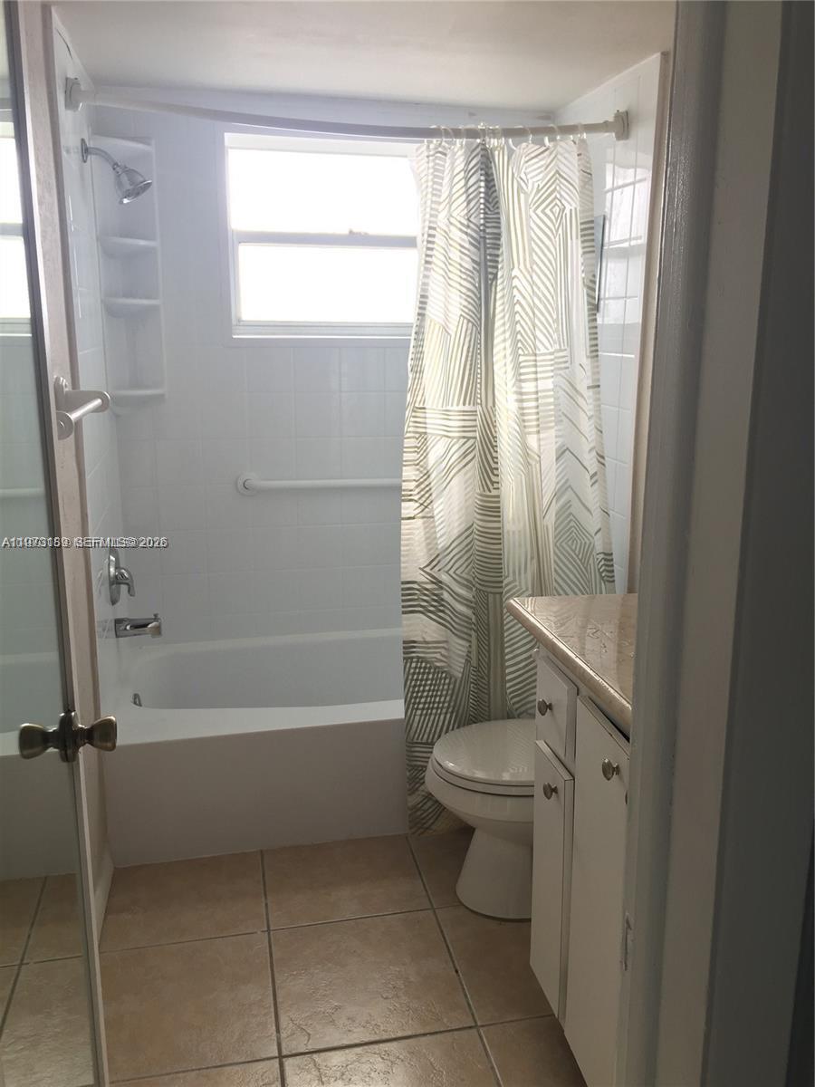 901 South Surf Road, Unit 402 Hollywood, FL 33019 - Photo 9 of 25 a bathroom with a granite countertop toilet a sink and a bathtub