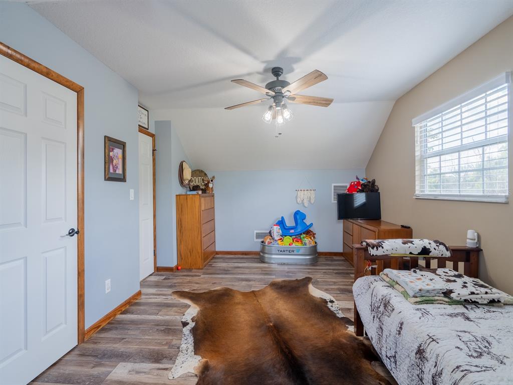 4381 Northeast 105th Place Anthony, FL 32617 - Photo 34 of 49 a bedroom with bed and window