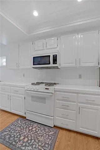 a kitchen with stainless steel appliances granite countertop a sink and a microwave
