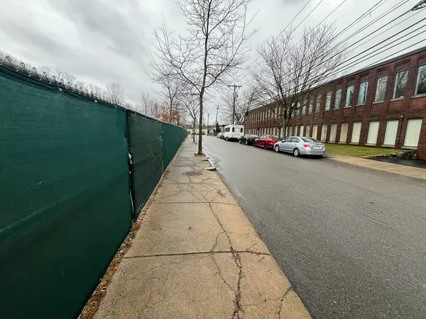 a view of a street with a building in the background