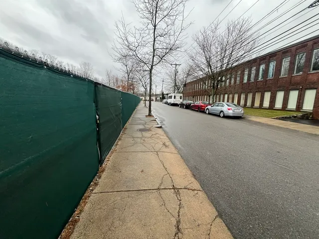 a view of a street with a building in the background