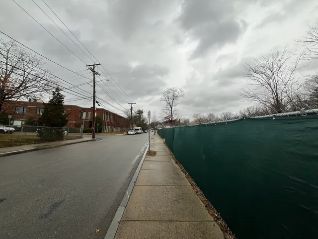 a view of a city street with a building in the background
