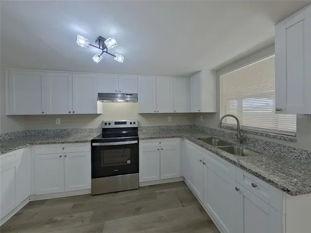 a kitchen with a sink and cabinets