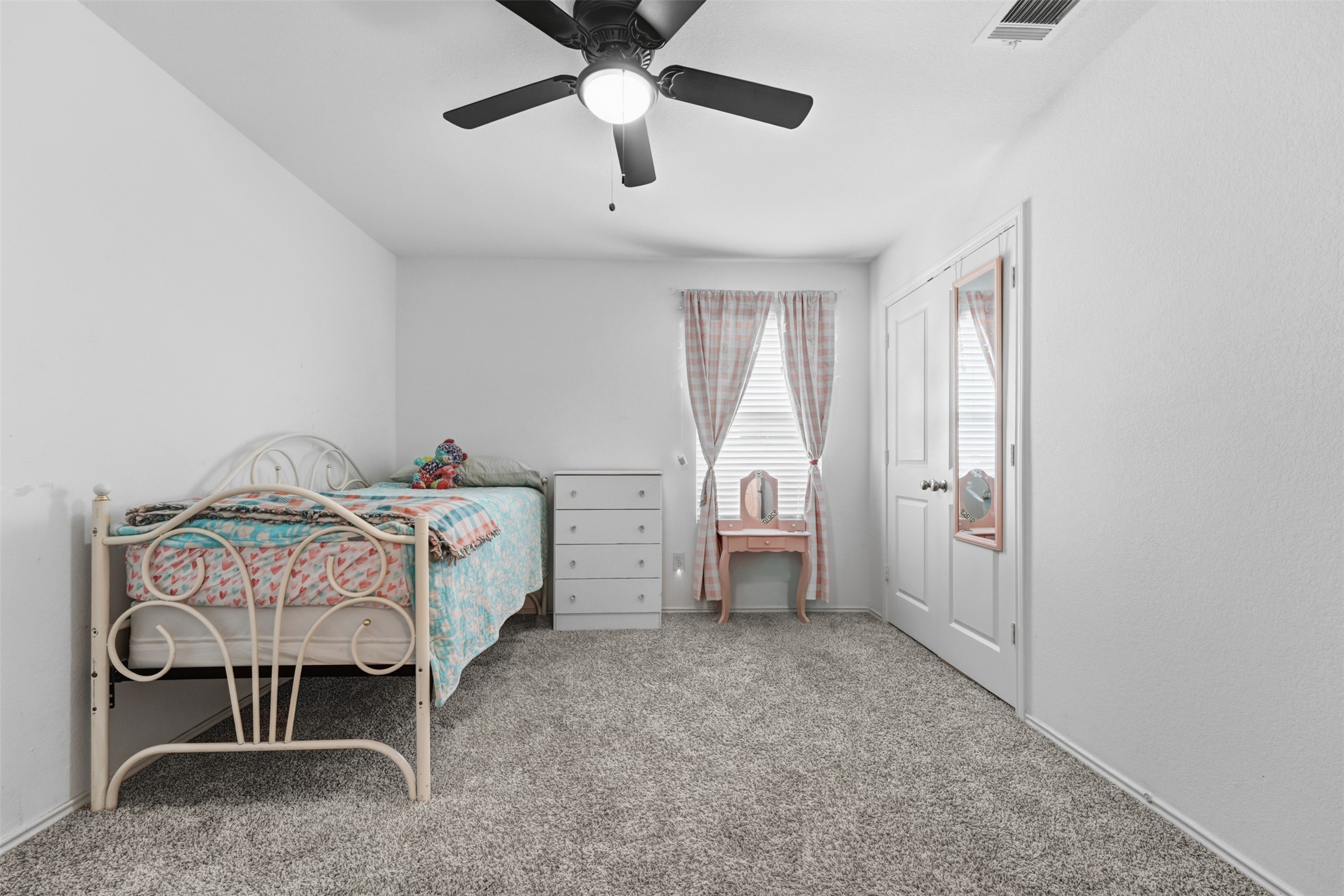 413 Perfect World Loop Jarrell, TX 76537 - Photo 28 of 39 Comfortable carpeted bedroom with a window, ceiling fan, and ample closet space.