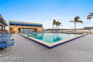 400 Lenell Road, Unit 110 Fort Myers Beach, FL 33931 - Photo 29 of 37 swimming pool view with outdoor seating space