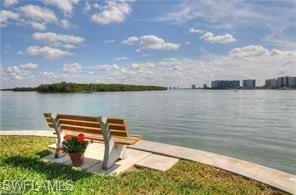 400 Lenell Road, Unit 110 Fort Myers Beach, FL 33931 - Photo 8 of 37 a view of a lake with table and chairs