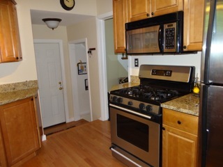 4708 Wolf Road Western Springs, IL 60558 - Photo 5 of 14 a kitchen with granite countertop a stove and a microwave