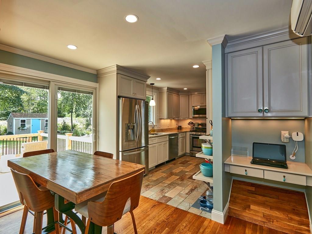 15 Highland Ridge Road Freetown, MA 02702 - Photo 19 of 42 a kitchen with a table chairs refrigerator and cabinets