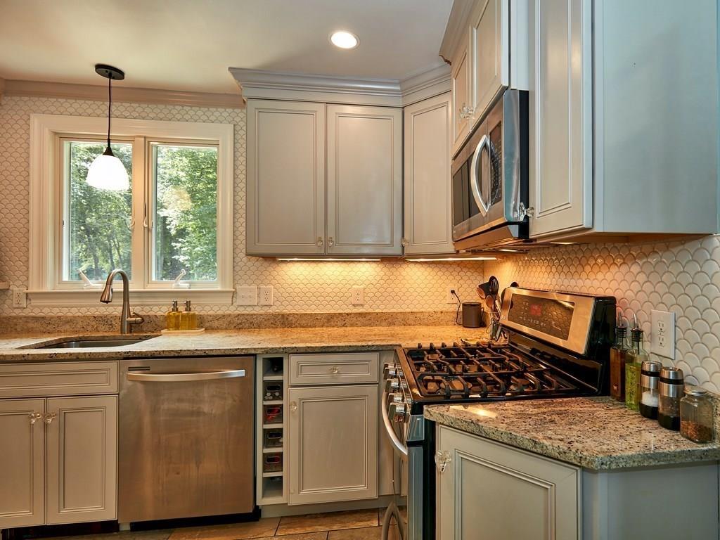 15 Highland Ridge Road Freetown, MA 02702 - Photo 24 of 42 a kitchen with granite countertop a sink stove and cabinets