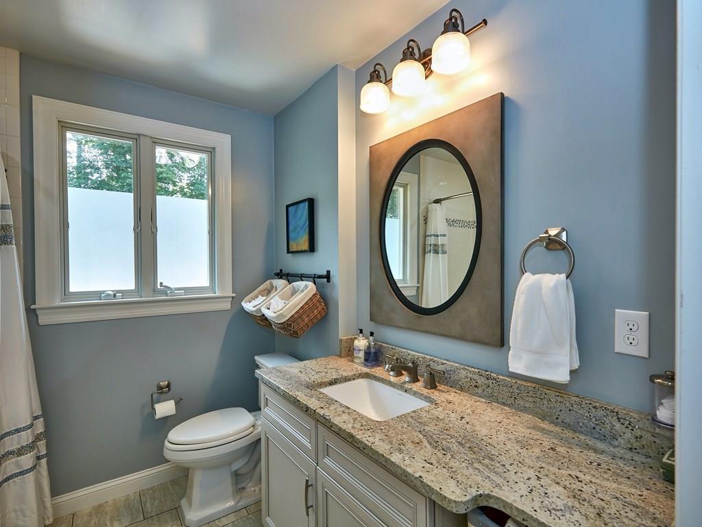 15 Highland Ridge Road Freetown, MA 02702 - Photo 25 of 42 a bathroom with a granite countertop toilet a sink and a mirror