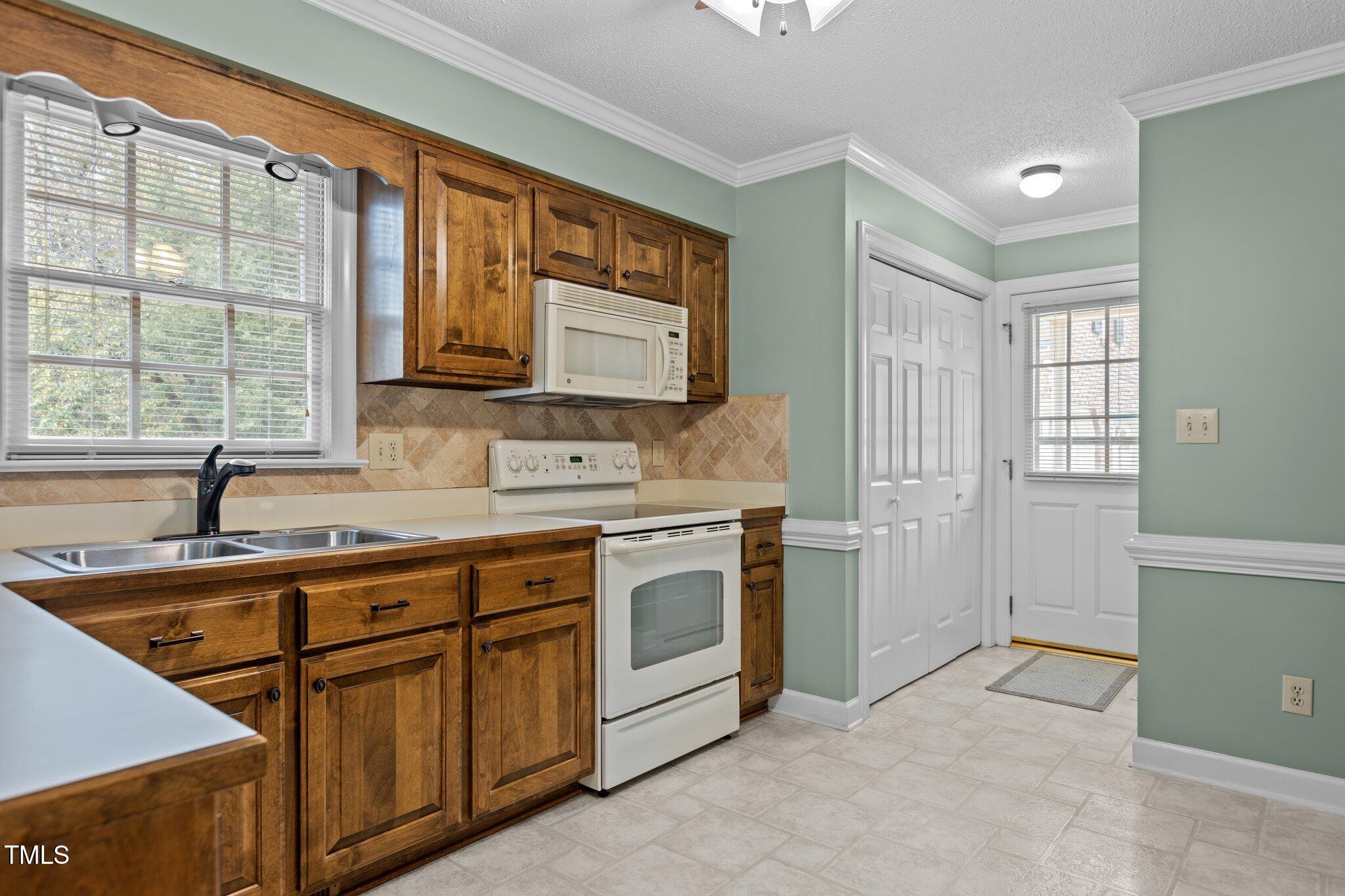 5940 Hampton Ridge Road Raleigh, NC 27603 - Photo 13 of 42 a kitchen with stainless steel appliances granite countertop a sink stove and cabinets