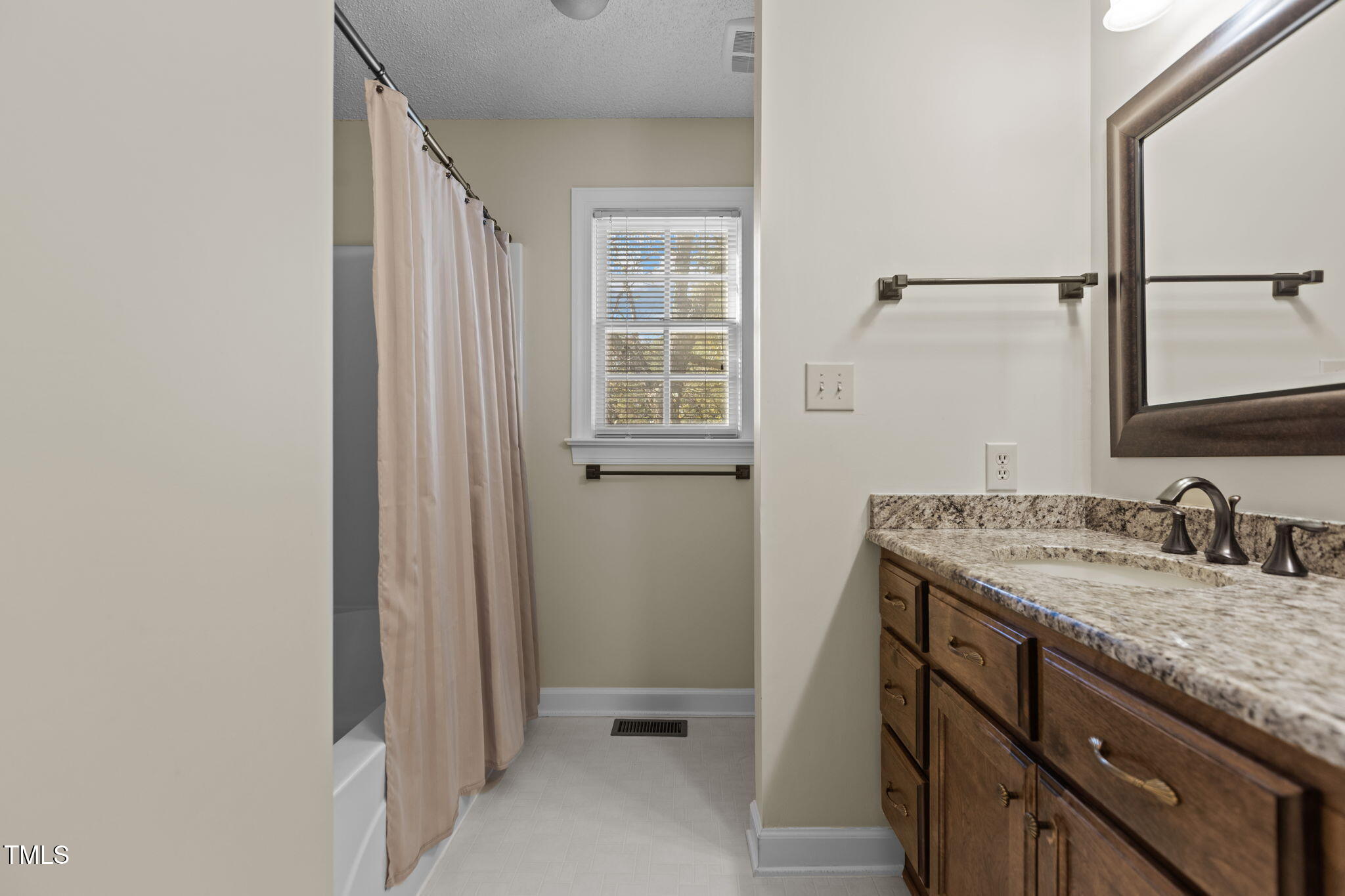 5940 Hampton Ridge Road Raleigh, NC 27603 - Photo 17 of 42 a bathroom with a granite countertop sink and a mirror