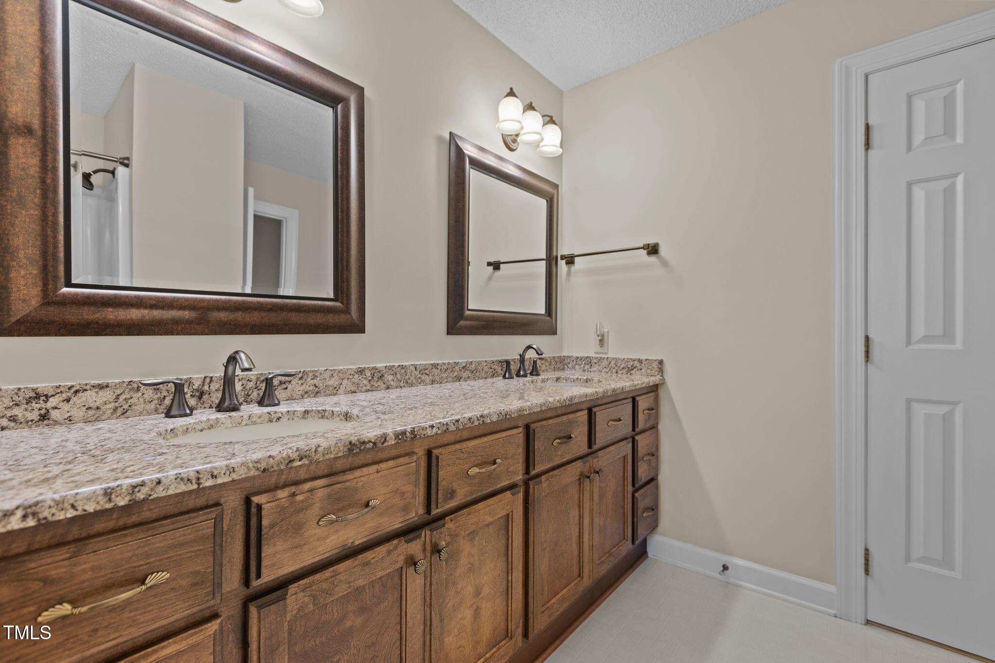 5940 Hampton Ridge Road Raleigh, NC 27603 - Photo 18 of 42 a bathroom with a granite countertop double vanity sink and a mirror