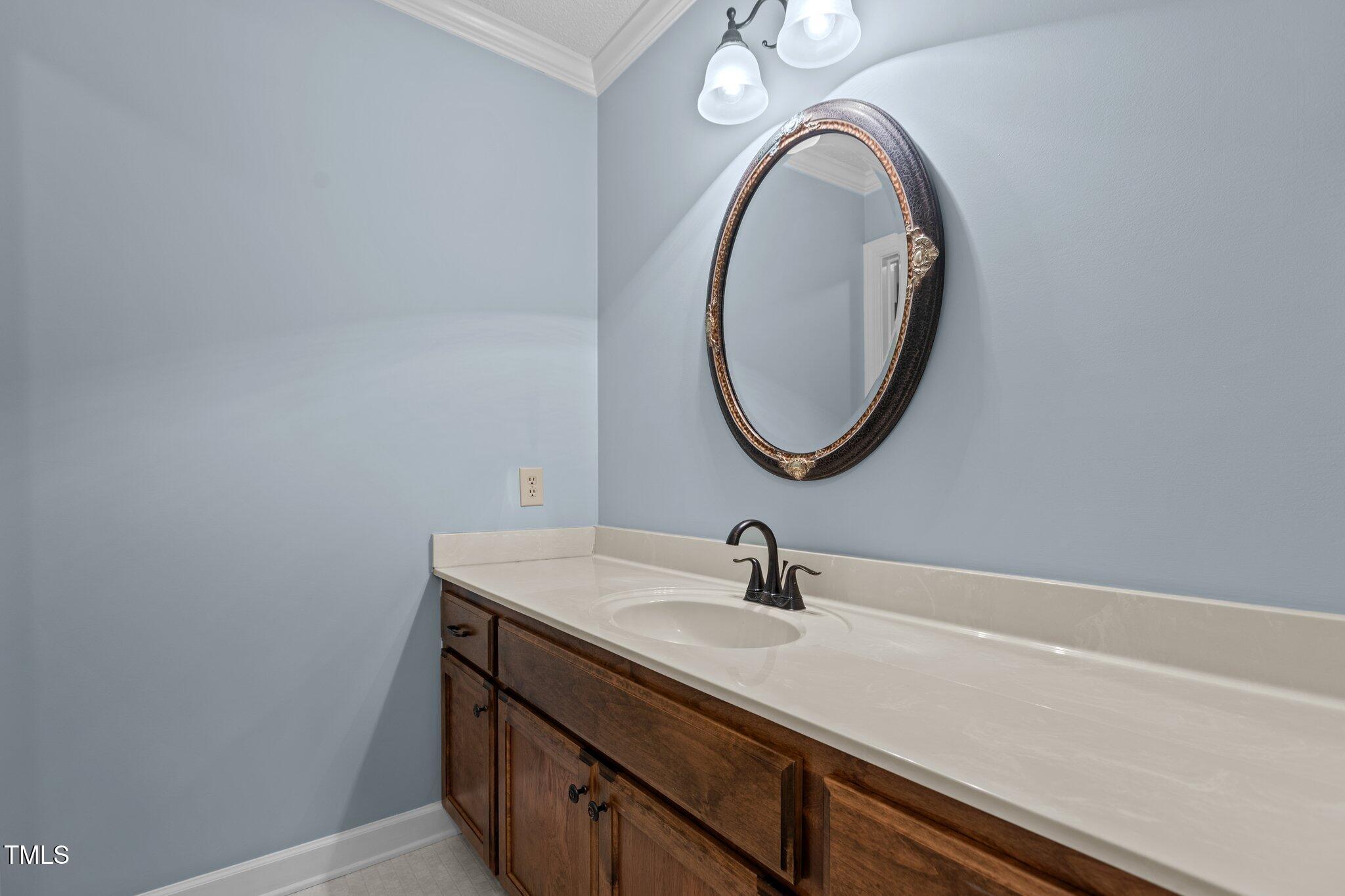 5940 Hampton Ridge Road Raleigh, NC 27603 - Photo 22 of 42 a bathroom with a sink and a mirror