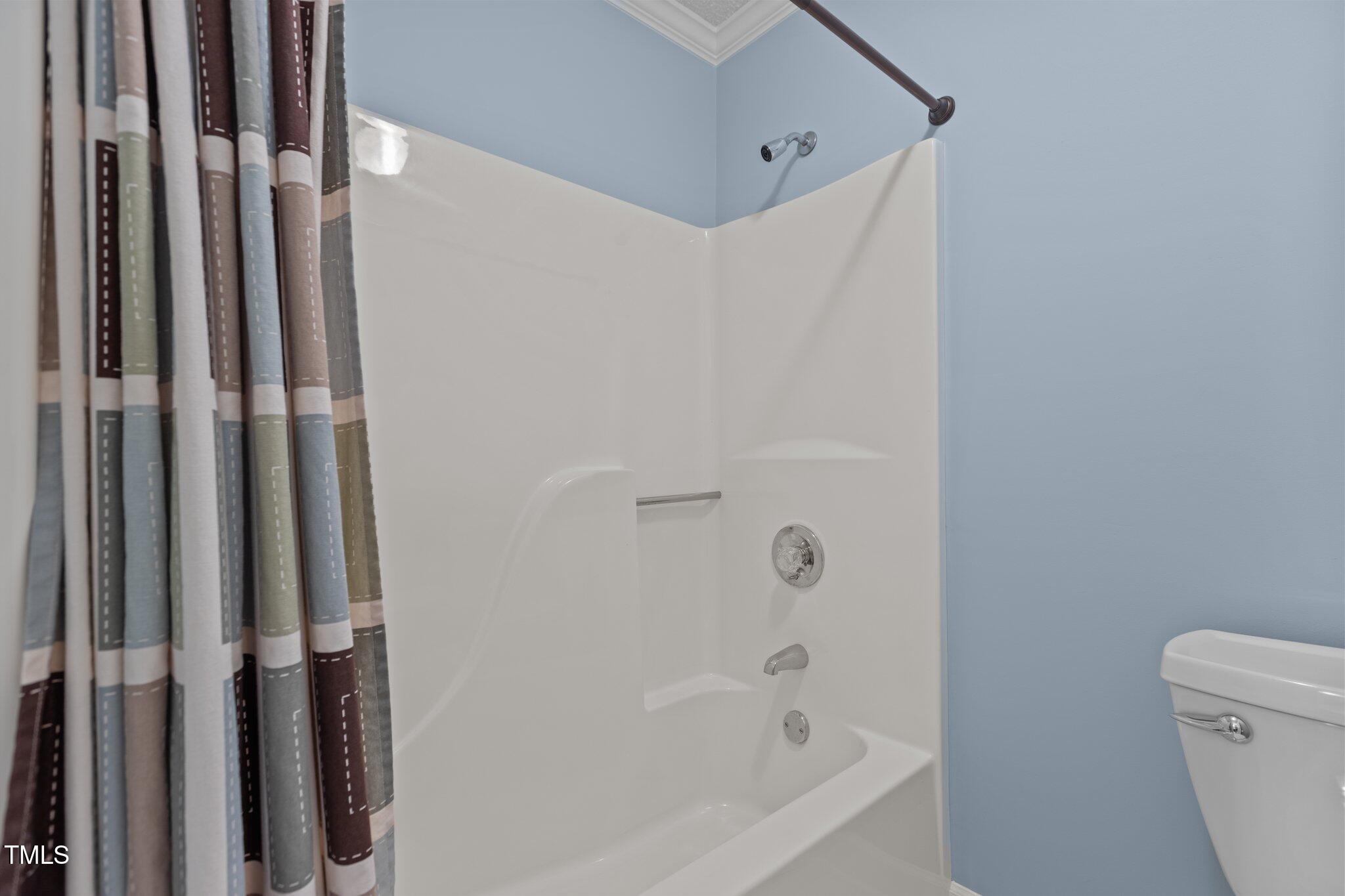 5940 Hampton Ridge Road Raleigh, NC 27603 - Photo 25 of 42 a bathroom with a bathtub and a shower
