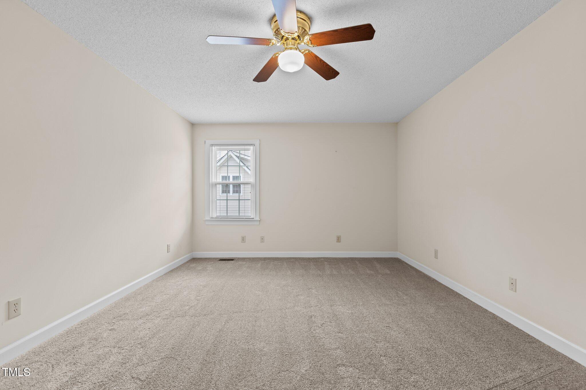 5940 Hampton Ridge Road Raleigh, NC 27603 - Photo 26 of 42 an empty room with chandelier fan