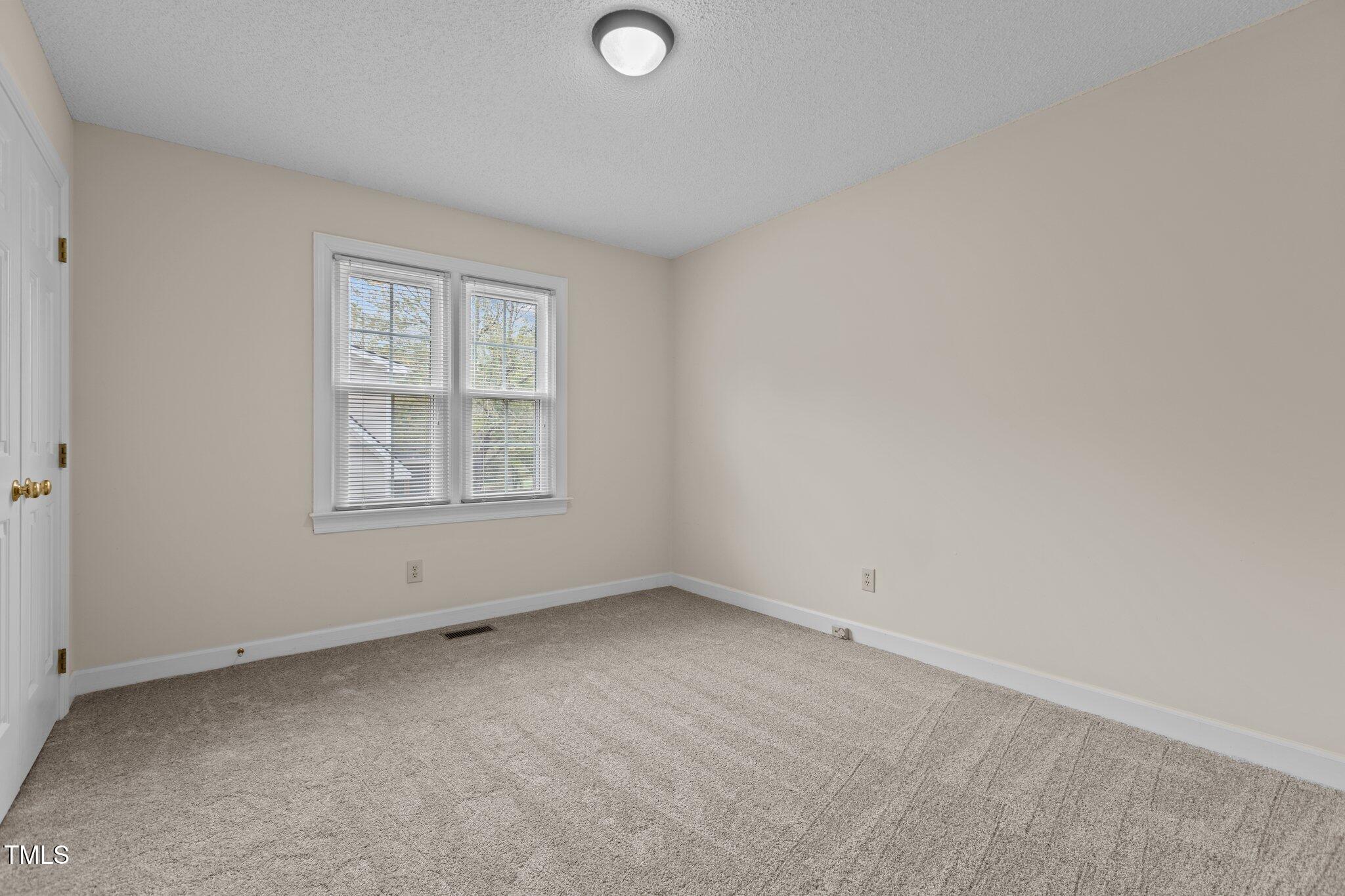 5940 Hampton Ridge Road Raleigh, NC 27603 - Photo 27 of 42 an empty room with windows