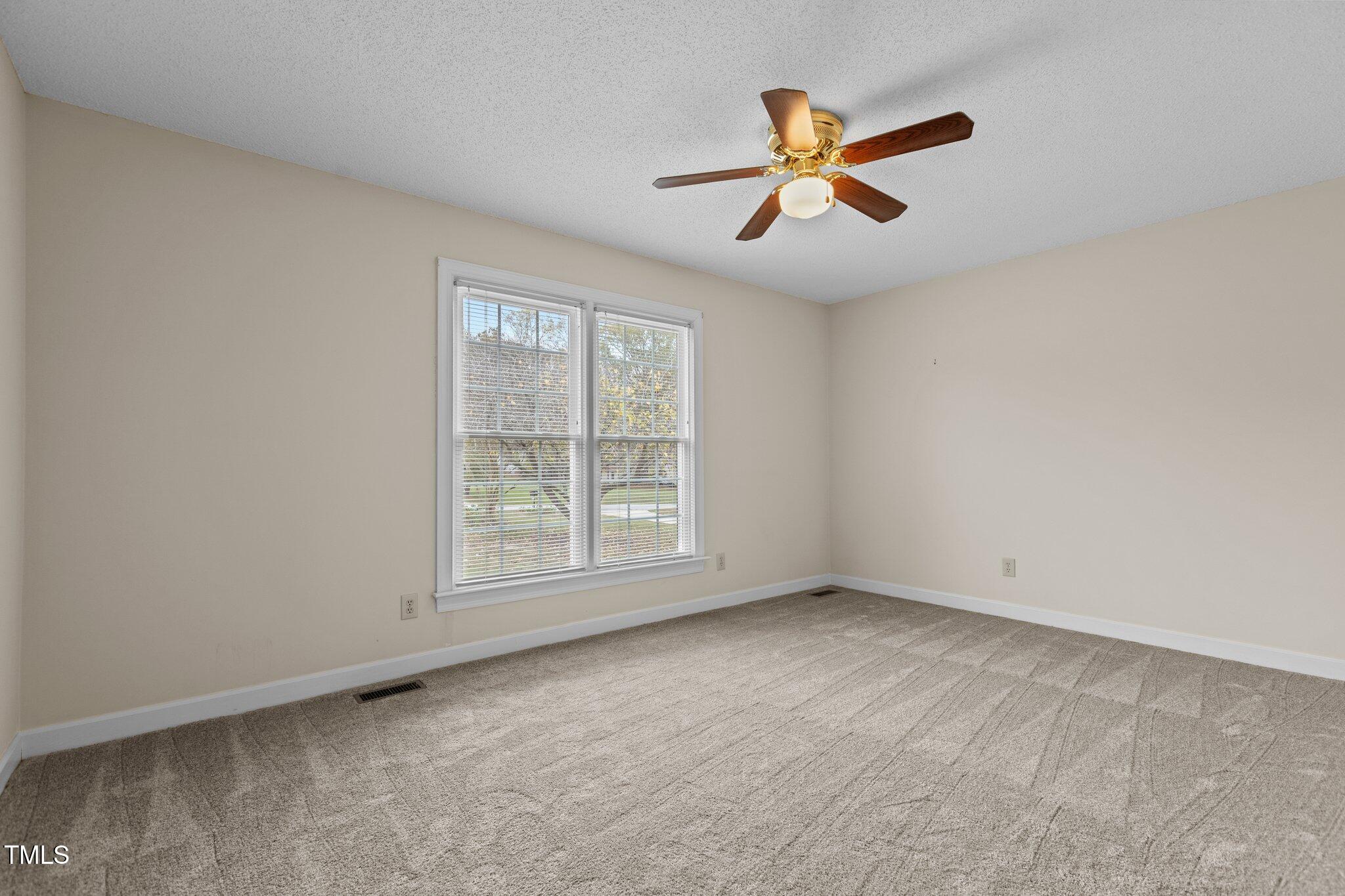5940 Hampton Ridge Road Raleigh, NC 27603 - Photo 28 of 42 an empty room with fan and windows