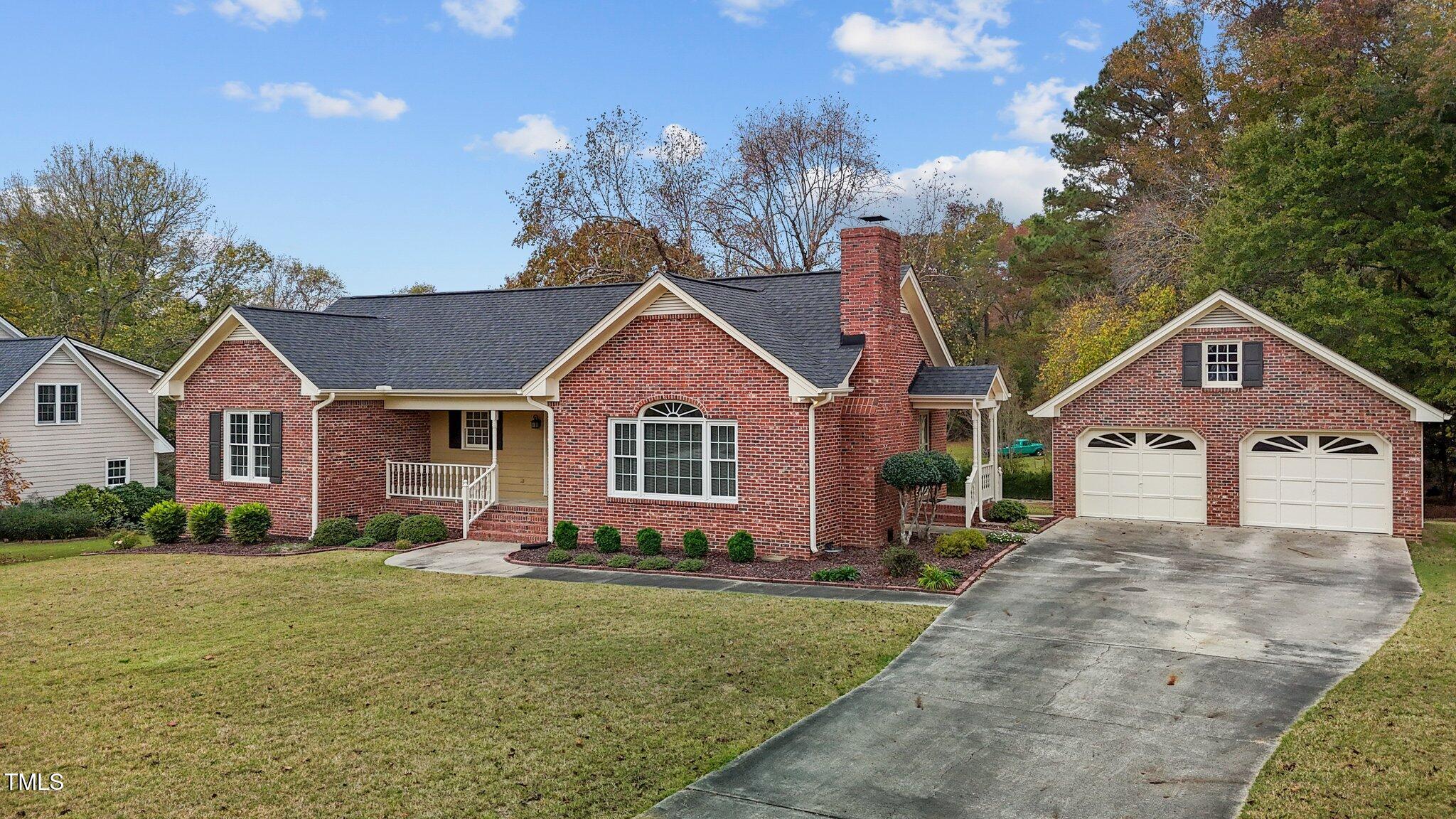 5940 Hampton Ridge Road Raleigh, NC 27603 - Photo 36 of 42 a front view of a house with a yard and garage