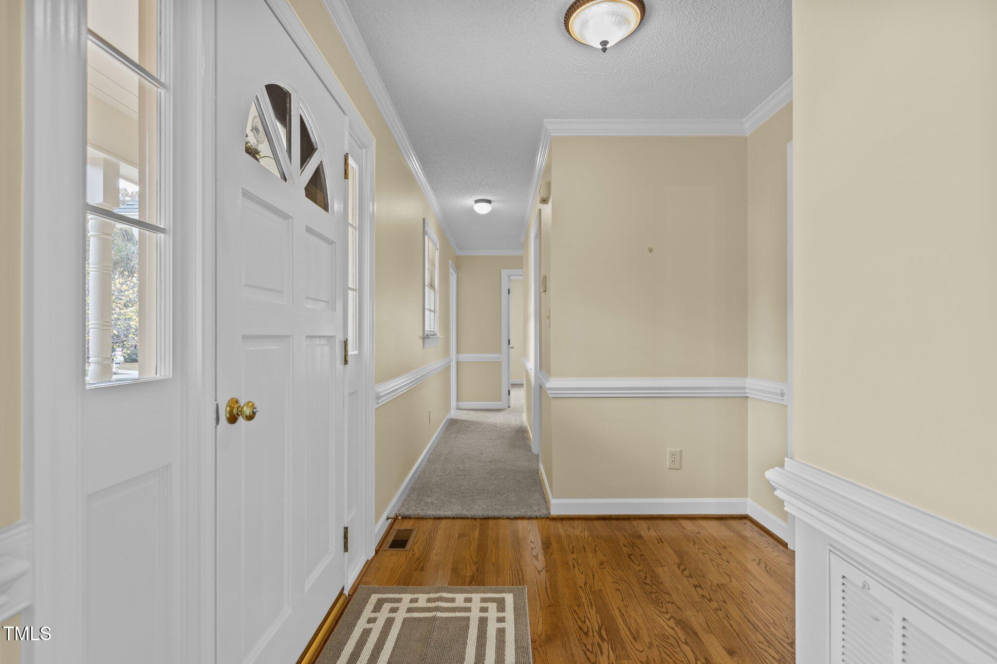 5940 Hampton Ridge Road Raleigh, NC 27603 - Photo 4 of 42 a view of a hallway with wooden floor and entryway