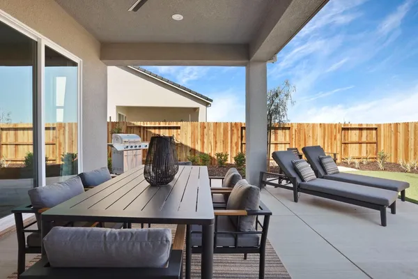 a living room with furniture and a floor to ceiling window