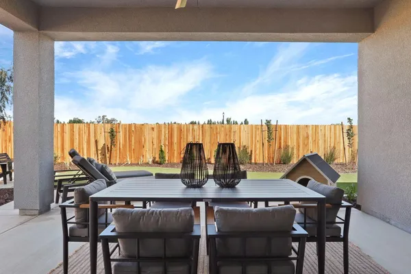 a view of a dining table and chairs in the patio