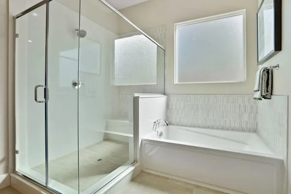 a bathroom with a bathtub and shower