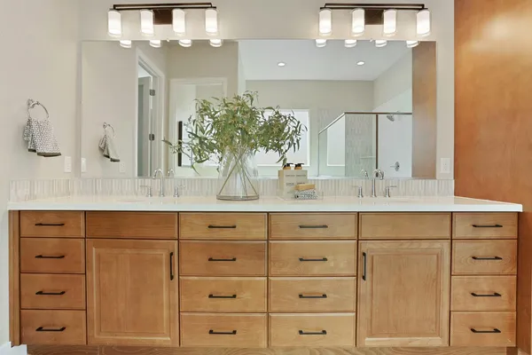 a bathroom with a sink vanity granite and a mirror