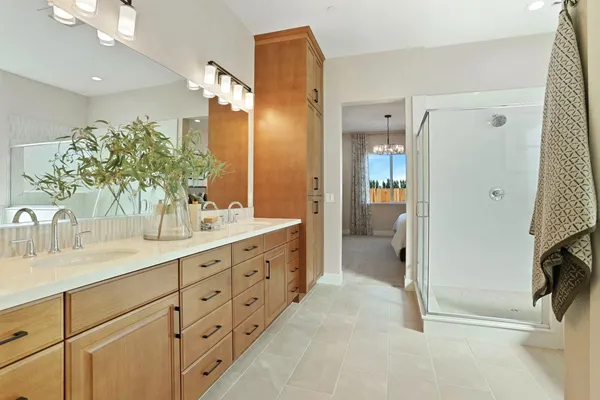 a spacious bathroom with double sink and shower