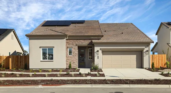a view of a brick house with large windows