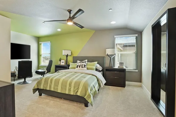 a bedroom with a bed and flat screen tv