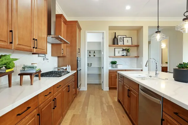 a large kitchen with stainless steel appliances granite countertop a stove a sink and a refrigerator