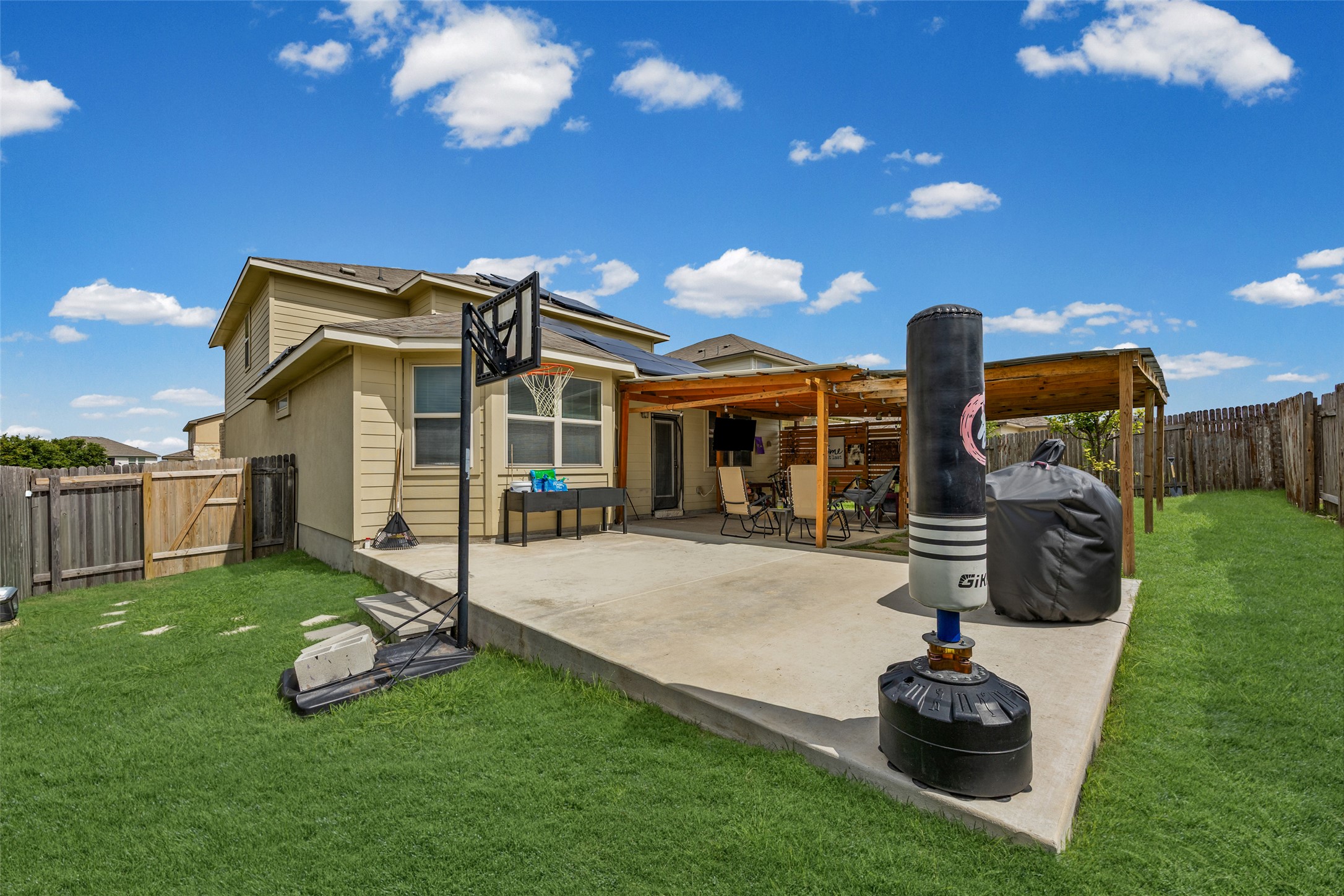 19113 Rookery Trail Pflugerville, TX 78660 - Photo 27 of 36 Expansive backyard featuring a concrete patio, a wood pergola, and a manicured lawn