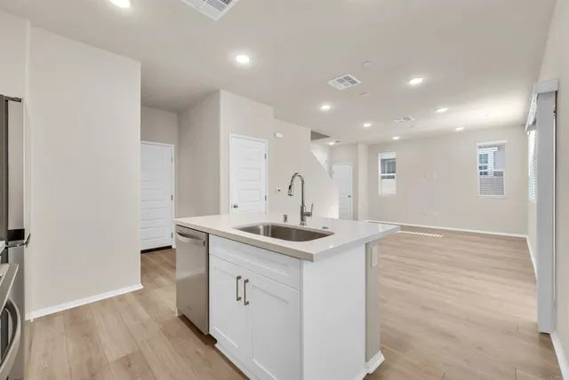a kitchen with stainless steel appliances granite countertop a sink and cabinets