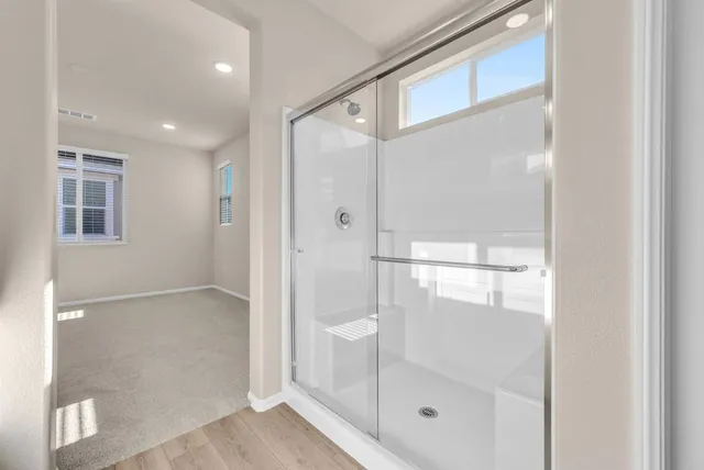 a bathroom with a glass shower door