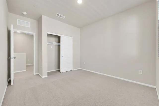 an empty room with closet area