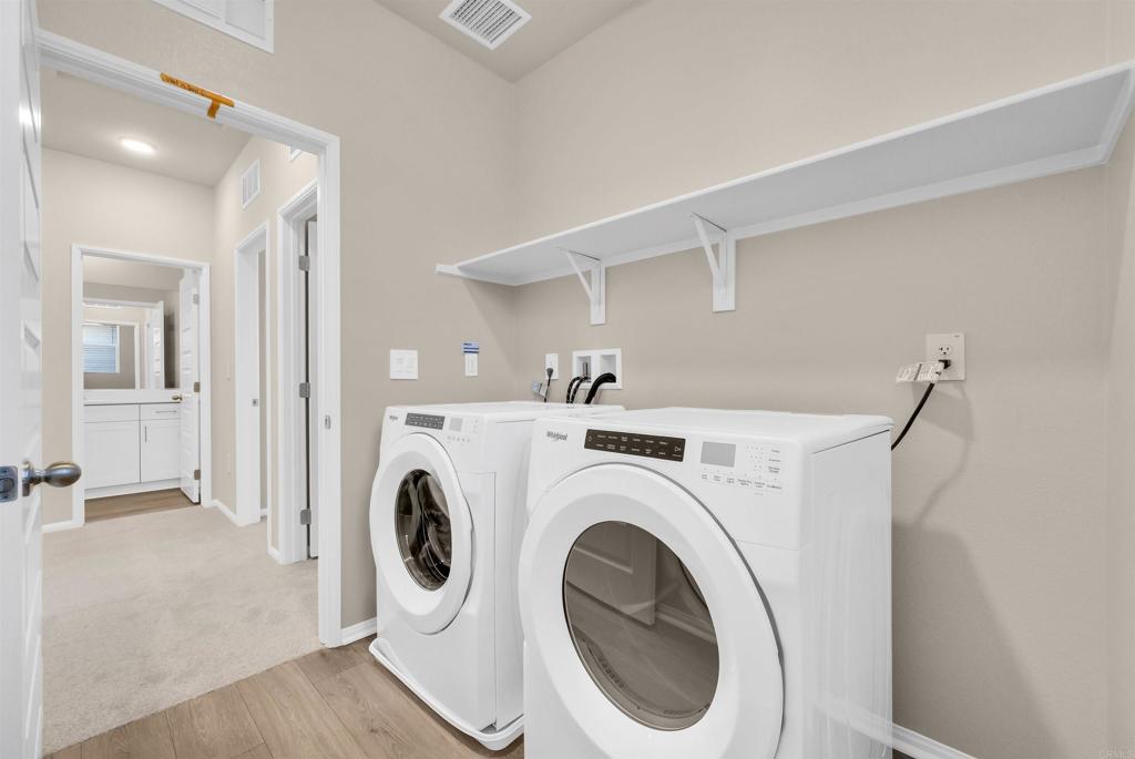 28381 Via Solero Temecula, CA 92591 - Photo 23 of 28 a view of a hallway with washer and dryer
