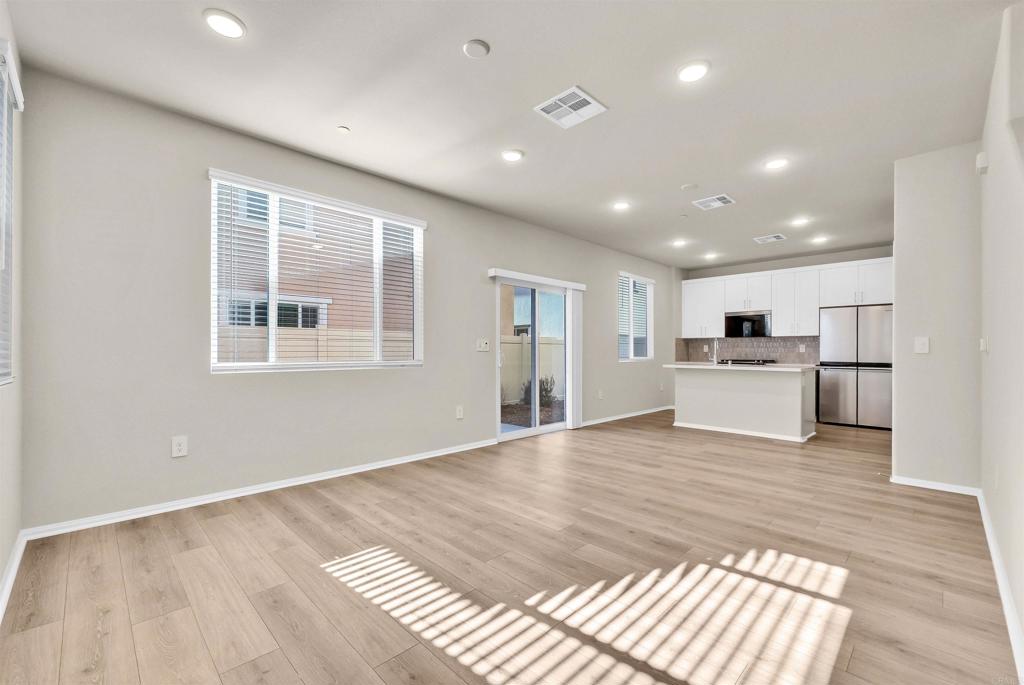 28381 Via Solero Temecula, CA 92591 - Photo 5 of 28 a view of an empty room with wooden floor and a window