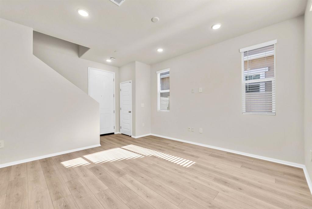 28381 Via Solero Temecula, CA 92591 - Photo 6 of 28 an empty room with wooden floor and windows