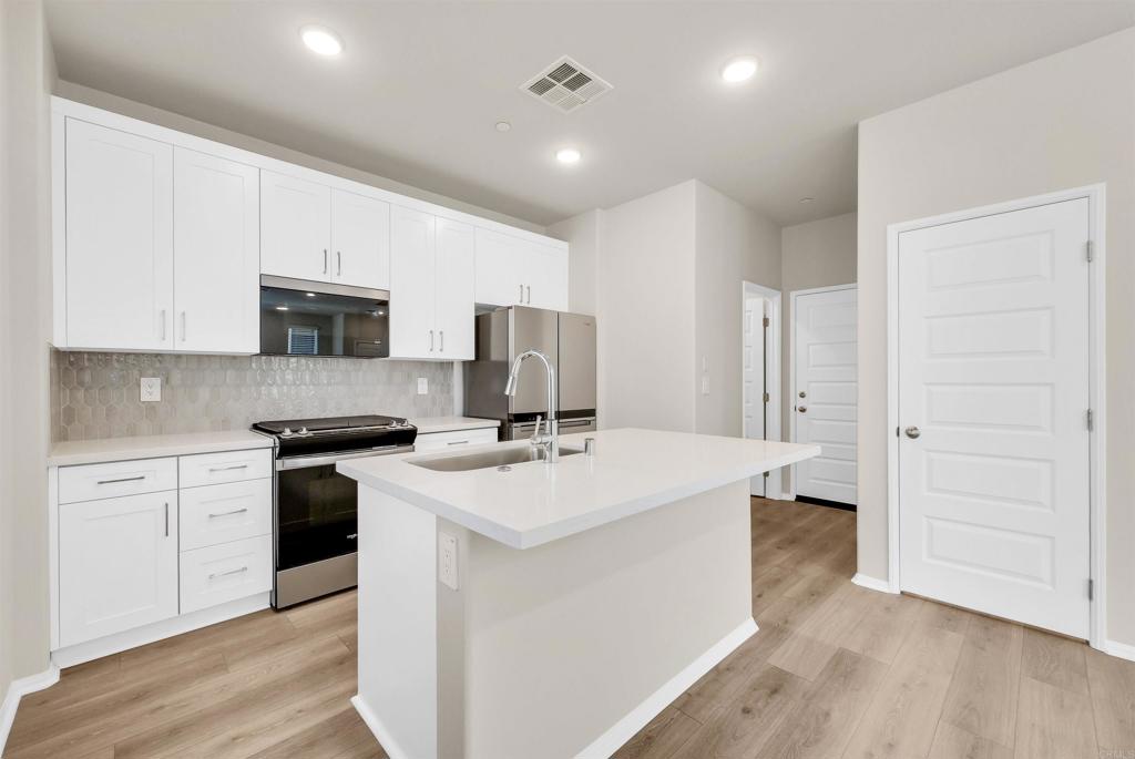28381 Via Solero Temecula, CA 92591 - Photo 10 of 28 a kitchen with a sink a stove a refrigerator and cabinets