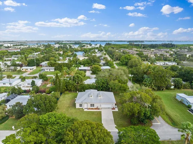 an aerial view of a houses with a yard