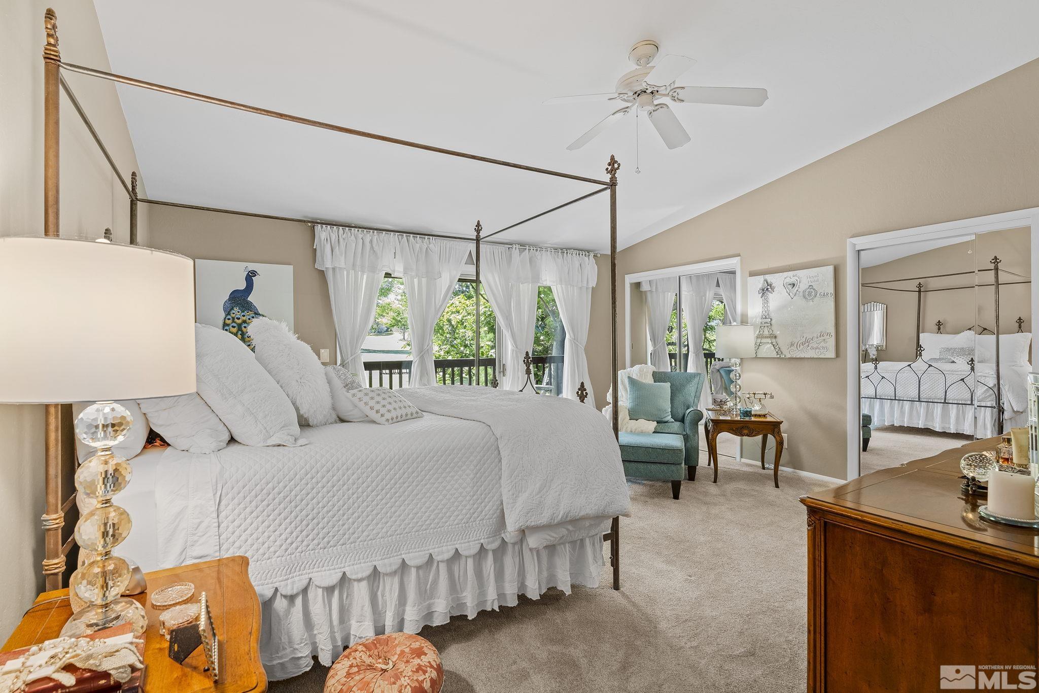 1947 South Villa Way Reno, NV 89509 - Photo 14 of 27 a bedroom with a bed mirror and a chandelier