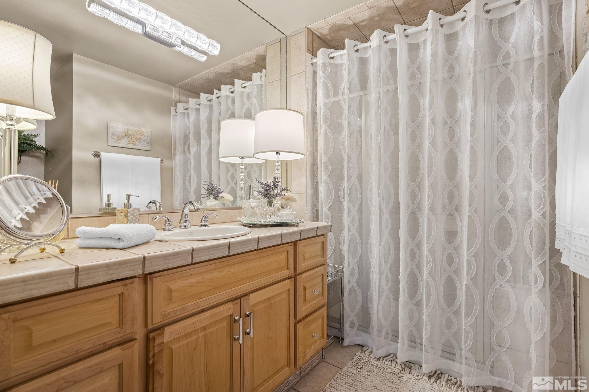 1947 South Villa Way Reno, NV 89509 - Photo 16 of 27 a bathroom with a double vanity sink and mirror