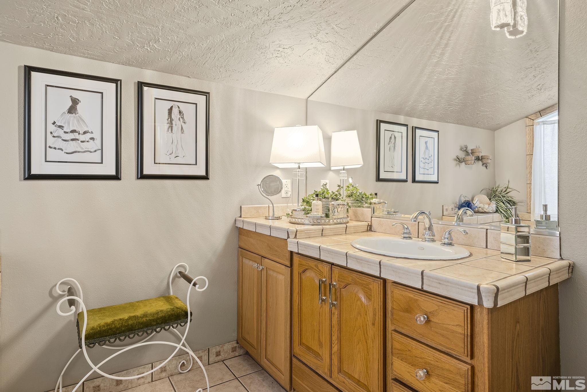 1947 South Villa Way Reno, NV 89509 - Photo 20 of 27 a bathroom with a sink and a mirror